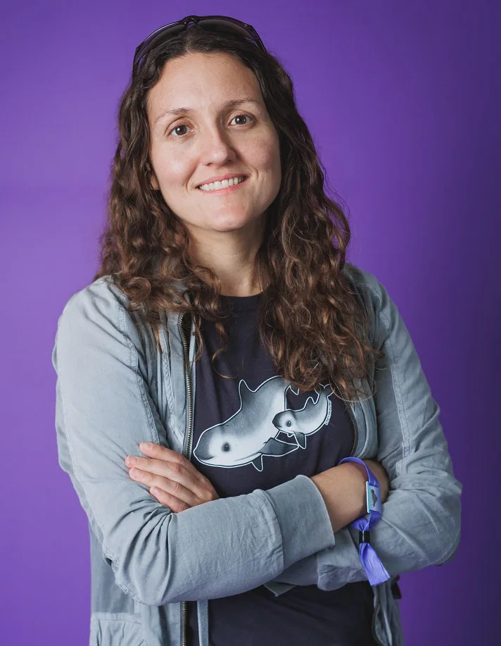 Kasey Snow, smiling, in a T-shirt with a drawing of a vaquita and her calf